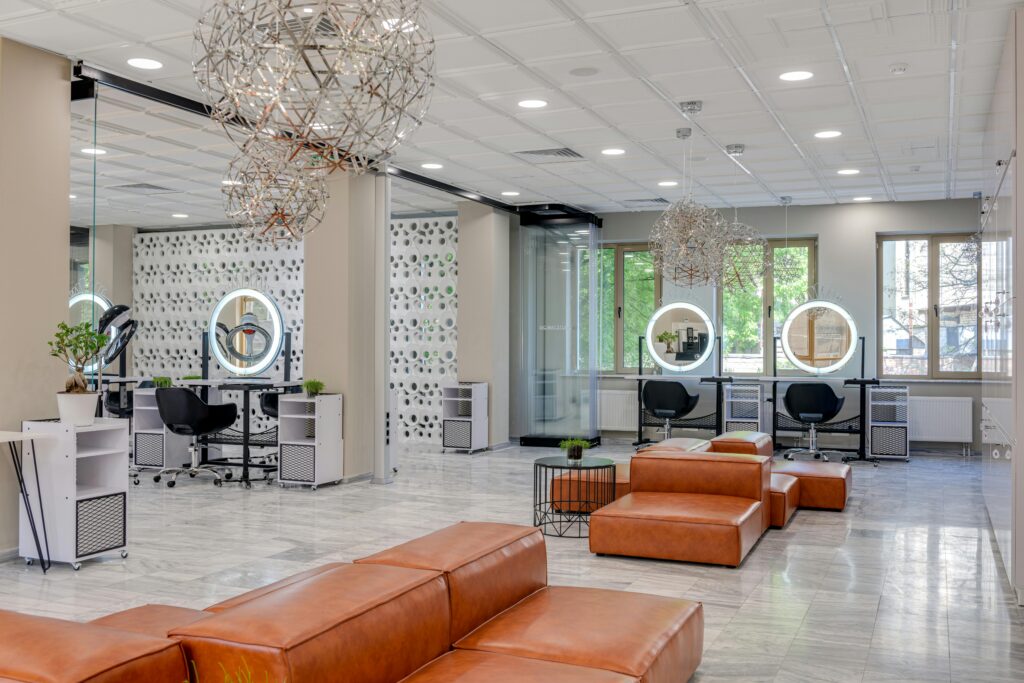 Stylish beauty salon interior with minimalist decor, spacious seating, and contemporary lighting.